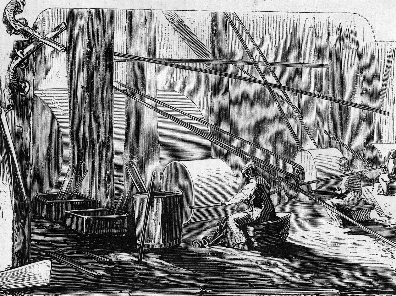 Fabrication de canons de fusil : polissage des cylindres de fer avec des roues en pierre. Gravure dans « Le Monde Illustré » n°35 du 12 décembre 1857. - French School