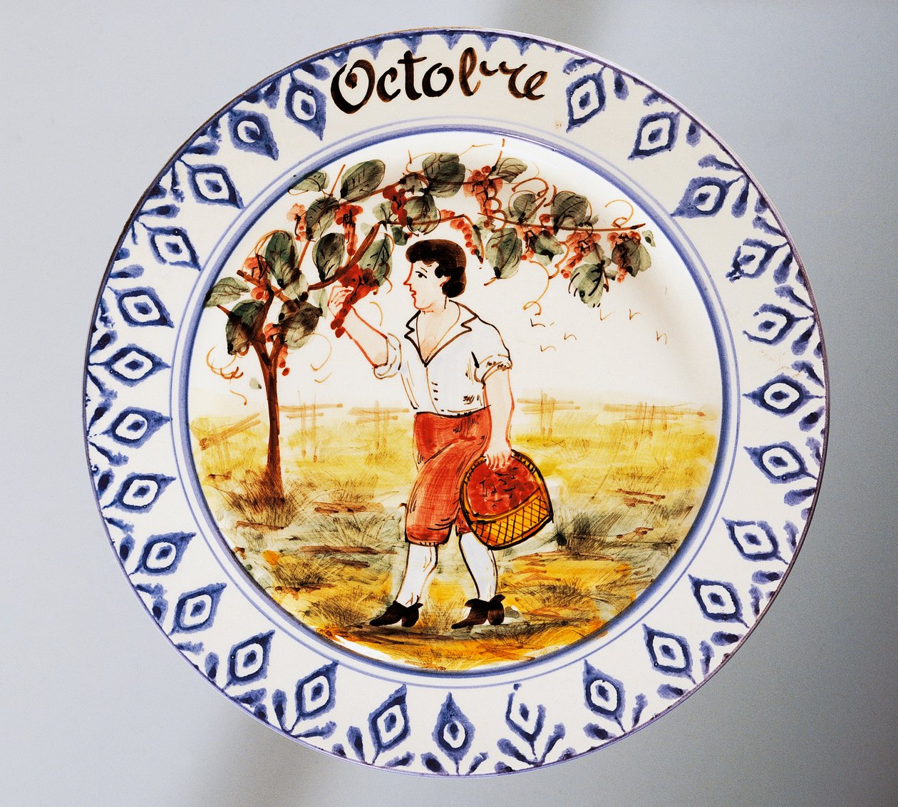 Assiette représentant des mois, octobre, faïence, fabrication Nove di Bassano, région de Vénétie, Italie, XXe siècle. - Italian School