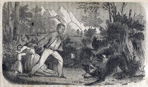 Un homme devant une femme et un enfant repoussant des chiens