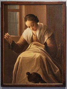 Jeune fille cousant