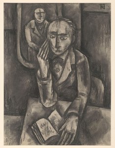 Homme assis à une table avec un livre ouvert