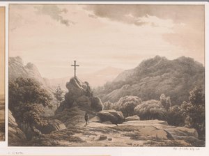 Paysage montagneux avec croix sur un rocher