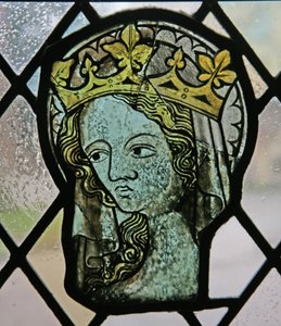 Fenêtre dans les cloîtres représentant une tête féminine (saintée et couronnée)