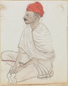 Homme avec un turban rouge assis en tailleur