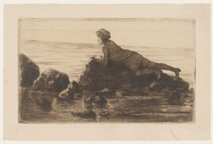 Garçon allongé sur des rochers sur la plage