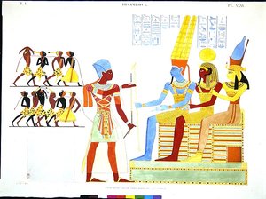 Un pharaon, en costume militaire, offre un groupe de prisonniers aux dieux Amon, Khonsu et Mout