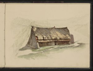 Grange avec un toit de chaume dans un pré