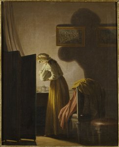 Une femme attrapant des puces à la lumière de la bougie
