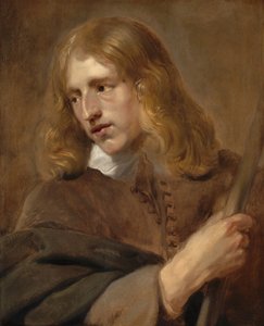 Un jeune homme tenant un bâton