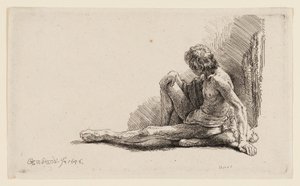 Homme nu assis par terre avec une jambe étendue