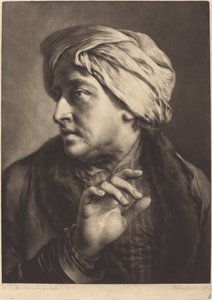 Un homme avec un turban et une chemise rayée