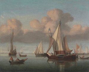 Un kaag au mouillage avec les voiles hissées et un yacht d