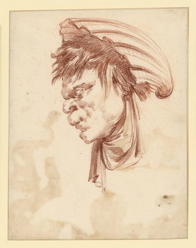 Tête grotesque vue de profil vers la gauche, coiffée d