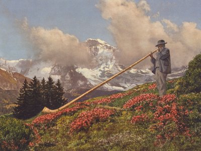 Suisse : Un joueur de cor des Alpes, la Jungfrau en arrière-plan - Jean Gaberell