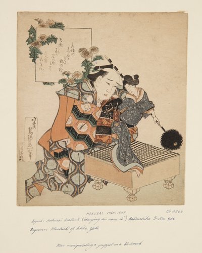 Marionnettiste tenant une marionnette sur un plateau de go (estampe sur bois en couleur) - Katsushika Hokusai