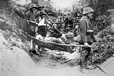 Soldats allemands de la Première Guerre mondiale portant un camarade blessé sur une civière improvisée, près de Soissons, juin 1918 - Photographer German