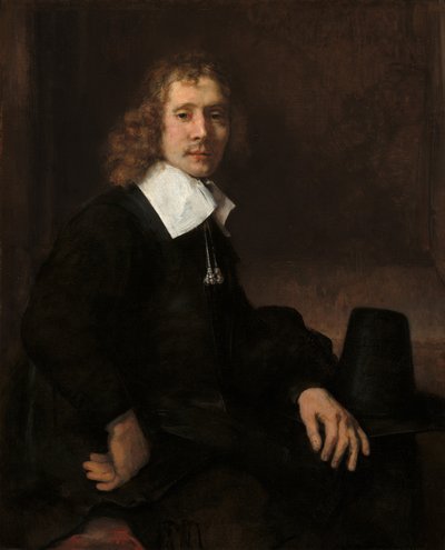 Un jeune homme assis à une table, possiblement Govaert Flinck, vers 1660 - Rembrandt van Rijn