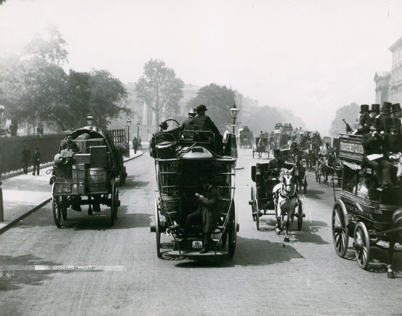 Trafic tiré par des chevaux sur une route animée - English Photographer