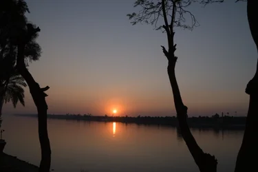 Reflets dorés du coucher de soleil sur une rivière paisible