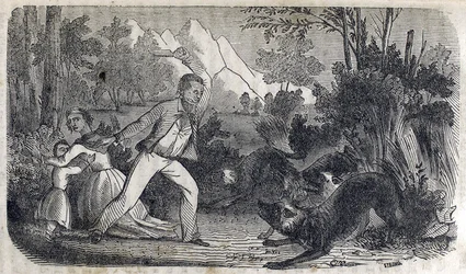 Un homme devant une femme et un enfant repoussant des chiens