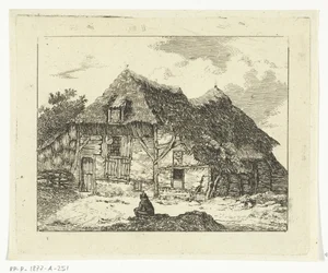 Homme assis sur une colline devant une maison à Staphorst