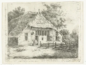 Femme penchée devant un panier devant une maison à Staphorst