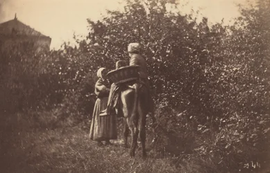 Deux femmes avec un âne, fin des années 1870 (photo)