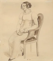 Une dame assise dans un fauteuil, tournée vers la fenêtre