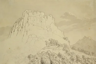 Sommet rocheux avec une colline boisée devant