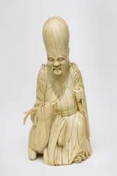 Figure en ivoire sculptée de Shou Xing assis avec un cerf, c.1580-1644