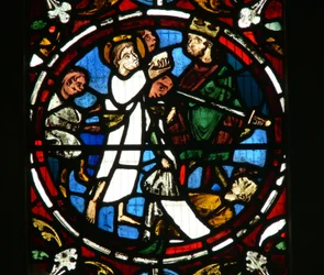 Fenêtre Ew représentant une scène de la légende de Saint Jean : le saint et la coupe empoisonnée