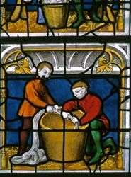 Fenêtre w25 représentant un drapier au travail dans la fenêtre des Drapiers