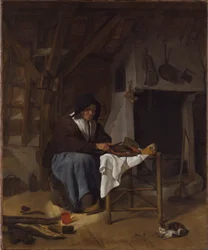 Vieille femme à son repas dans un intérieur
