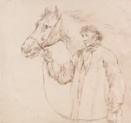 Homme tenant un cheval par la bride