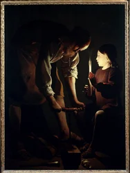 Saint Joseph charpentier Jésus enfant tient une bougie pour éclairer son père Joseph au travail. Peinture de Georges de La Tour (1593-1652) 1640 Paris. Musée du Louvre
