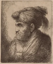 Homme avec une barbe et un couvre-chef à glands, face à gauche
