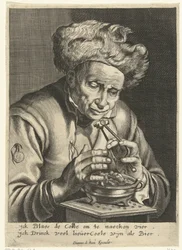 Vieil homme soufflant sur un morceau de charbon