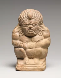 Hochet en forme de Yaksha grotesque accroupi