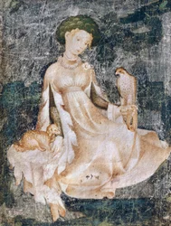 Femme assise par terre avec un chien et un faucon