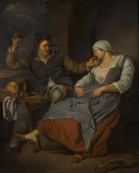 Un couple assis buvant du vin