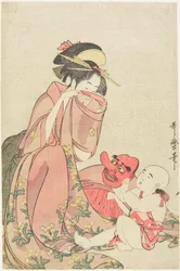 Femme jouant avec un enfant portant un masque de Tengu