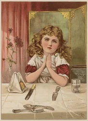 Fille disant la grâce avant le repas