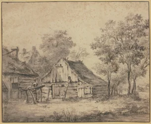 Maisons sous des arbres, avec une roue montée sur un poteau