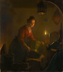 Une femme dans une cuisine à la lumière des bougies