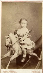 Jeune fille assise sur un cheval à bascule, 1860s