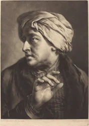Un homme avec un turban et une chemise rayée