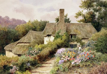 A Cottage at Selworthy, Somerset, England. Une femme dans le jardin d