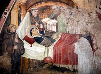 La mort de sainte Scholastique (v. 480 - v. 543), sœur de saint Benoît de Nursie. Elle est entourée de moines bénédictins. Fresque de l’école ombrienne du XVe siècle. Monastère Saint-Benoît (Sacro Speco), Subiaco (Rome), Italie